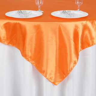 Experience Luxury with the Orange Square Smooth Satin Table Overlay