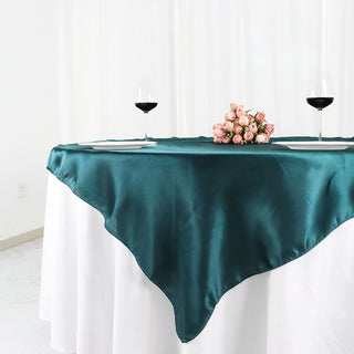 Elevate Your Table Decor with the Peacock Teal Square Satin Table Overlay