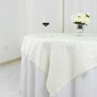 Create a Memorable Event with our Ivory Accordion Crinkle Taffeta Table Overlay
