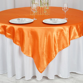 Experience Luxury with the 72x72 Orange Seamless Satin Square Tablecloth Overlay