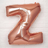 Rose gold foil letter Z balloon on a white background.