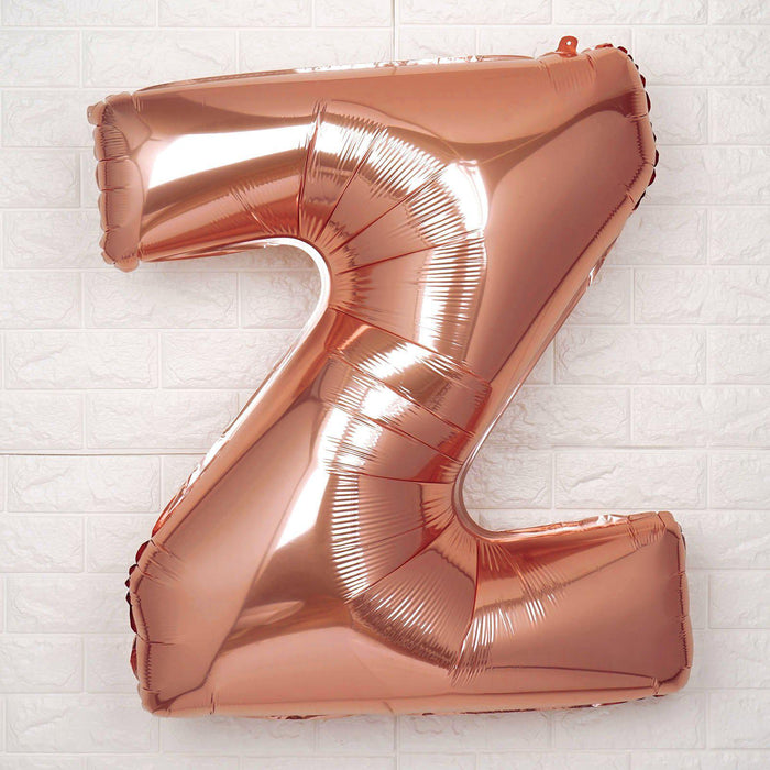 Rose gold foil letter Z balloon on a white background.