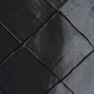 Black quilted fabric texture close-up shot. #whtbkgd