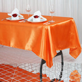 Add a Pop of Color to Your Event with the Orange Satin Tablecloth