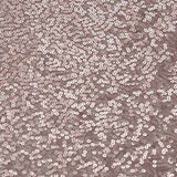 Close-up of shimmering rose gold sequin fabric texture.
