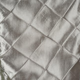 Silver quilted fabric texture with a shiny finish.