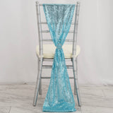 Turquoise sequin chair sash tied with a ring on a silver chair.