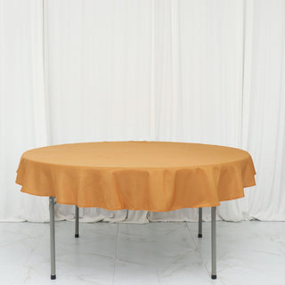 Add Elegance to Your Event with the 70" Round Gold Seamless Polyester Linen Tablecloth