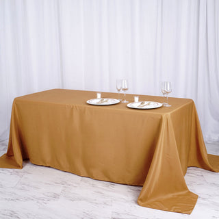 Add Elegance to Your Event with the 90"x156" Gold Seamless Polyester Rectangular Tablecloth