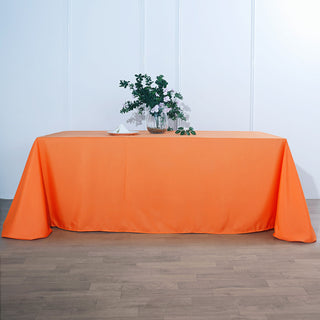 Brighten Up Your Event with the 90"x156" Orange Seamless Polyester Rectangular Tablecloth