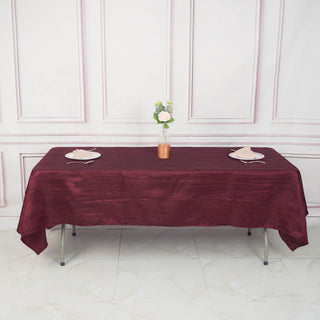 Add Elegance to Your Event with the Burgundy Accordion Crinkle Taffeta Seamless Rectangle Tablecloth
