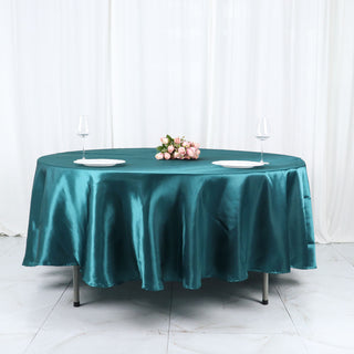 Elevate Your Event with the Peacock Teal 108" Seamless Satin Round Tablecloth