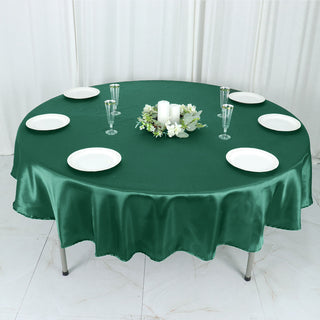Experience Luxury and Durability with the Hunter Emerald Green Seamless Satin Round Tablecloth