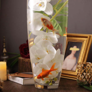 Orchid vase with goldfish in water, styled with decor elements.