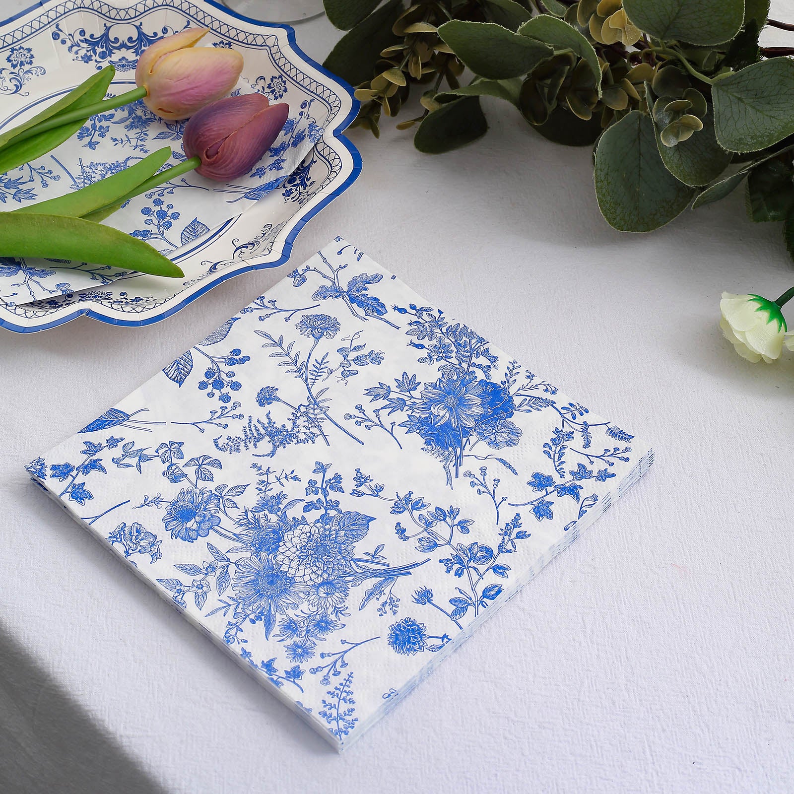 https://tableclothsfactory.com/cdn/shop/products/White-Blue-Chinoiserie-Floral-Print-Paper-Napkins.jpg?v=1689408283