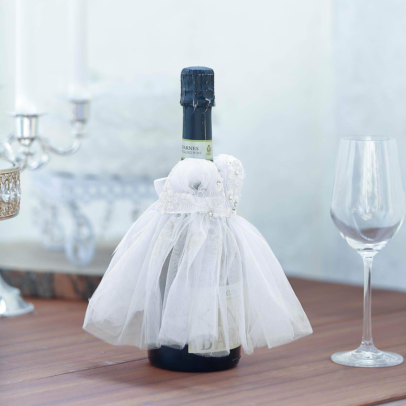 https://tableclothsfactory.com/cdn/shop/products/White-Bridal-Wedding-Dress-Wine-Bottle-Koozie.jpg?v=1689407576