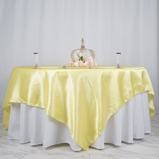 Create a Festive Atmosphere with a Yellow Satin Table Overlay